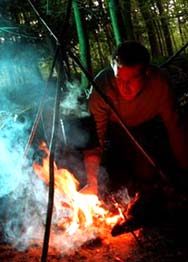 Ditchmonkey cooking snake on the fire